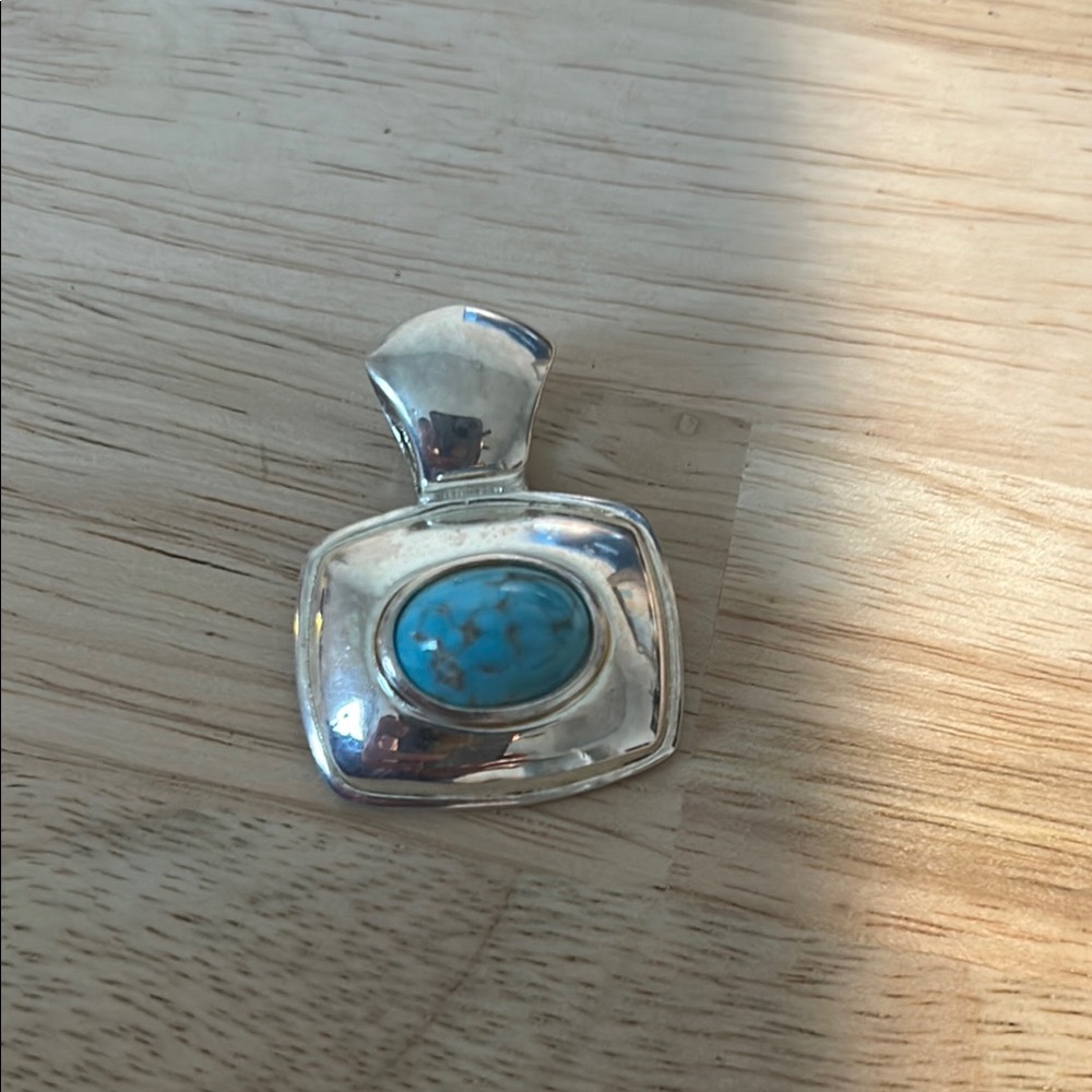 Silver Pendant with Turquoise Stone
Costume jewelry but looks good!